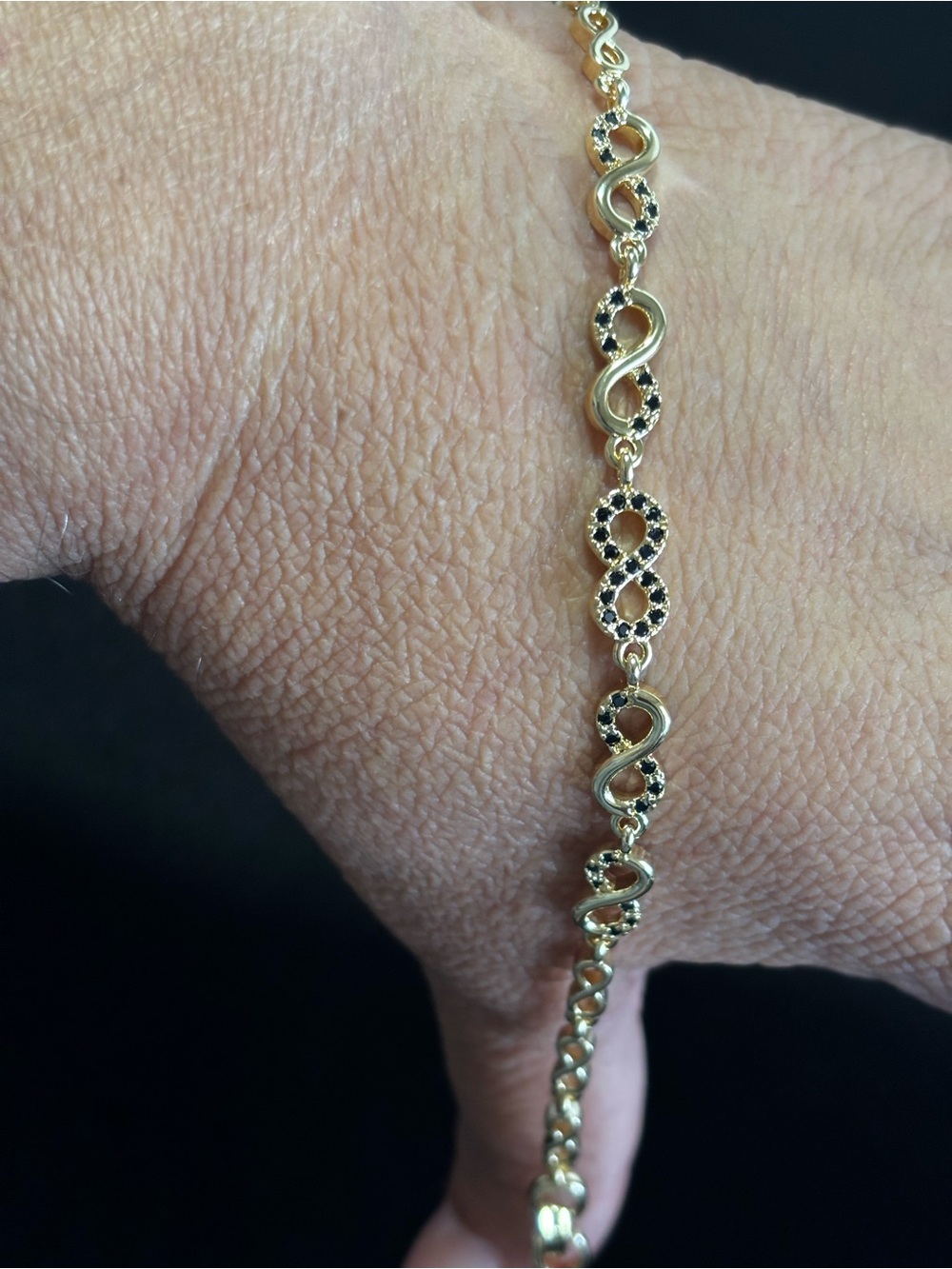 Gold Tone Infinity Link Bracelet with Black Accent Stones Laminated gold